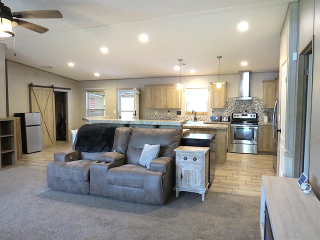 14547 Oak Leaf Loop, Splendora, TX 77372 - living area with a barn door, plenty of natural light, recessed lighting, a ceiling fan, and light colored carpet