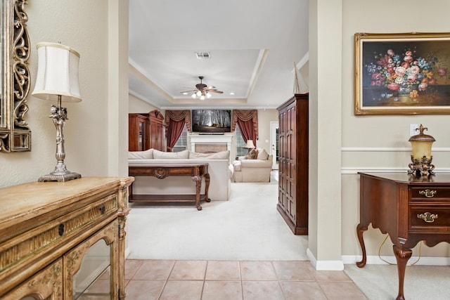 tiled bedroom featuring ornamental molding and a raised ceiling