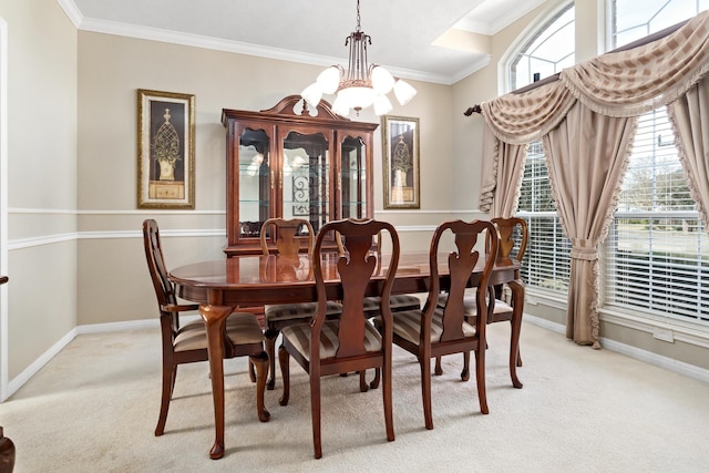 dining room featuring crown molding, light carpet, and an inviting chandelier