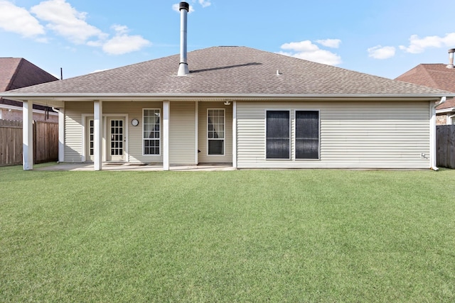 rear view of house with a lawn and a patio area