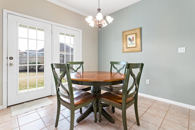 dining space featuring an inviting chandelier, crown molding, and light tile patterned flooring