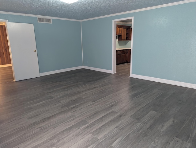 spare room featuring crown molding, dark hardwood / wood-style floors, and a textured ceiling