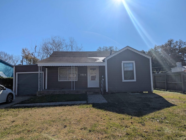 view of front of property with a garage, a porch, and a front lawn