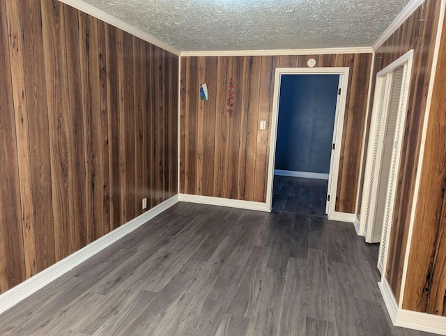 unfurnished room with ornamental molding, dark hardwood / wood-style flooring, and a textured ceiling