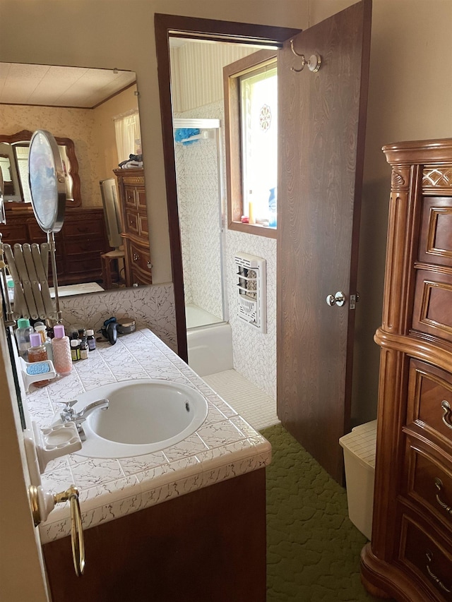 bathroom featuring washtub / shower combination, heating unit, and vanity