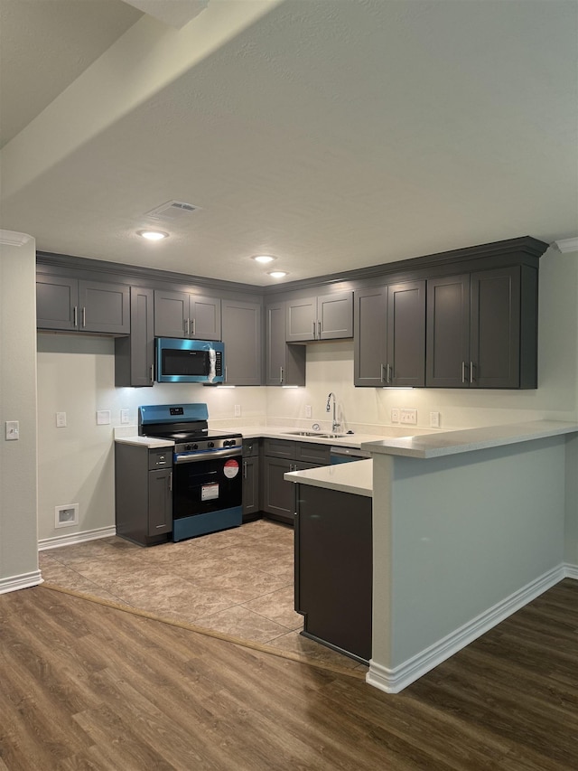 kitchen featuring gray cabinets, black range, and dark hardwood / wood-style floors