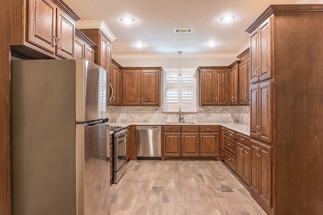 kitchen featuring tasteful backsplash, crown molding, sink, and appliances with stainless steel finishes