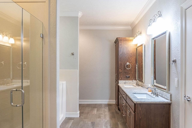 bathroom featuring hardwood / wood-style floors, vanity, an enclosed shower, and ornamental molding