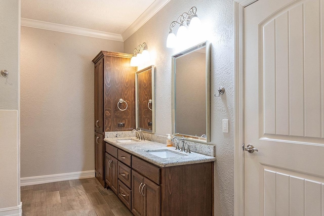 bathroom featuring wood-type flooring, vanity, and crown molding