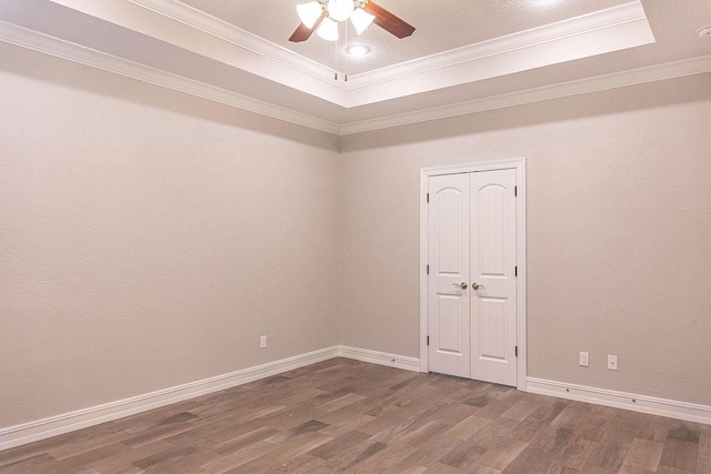 3865 E Pointe Dr, Beaumont, TX 77706 - empty room with wood finished floors, a tray ceiling, ceiling fan, crown molding, and baseboards