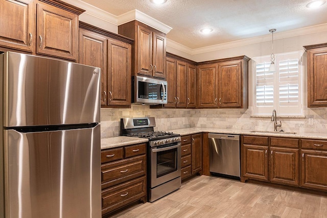 kitchen with decorative backsplash, light stone countertops, sink, and appliances with stainless steel finishes