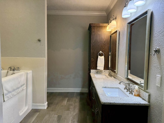 3865 E Pointe Dr, Beaumont, TX 77706 - bathroom featuring wood finished floors, double vanity, ornamental molding, and a garden tub