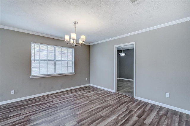 5960 Meadow Way, Beaumont, TX 77707 - spare room featuring wood finished floors, a chandelier, ornamental molding, a textured ceiling, and baseboards