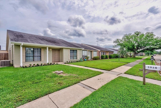 5960 Meadow Way, Beaumont, TX 77707 - ranch-style home featuring brick siding, central AC, and a front yard