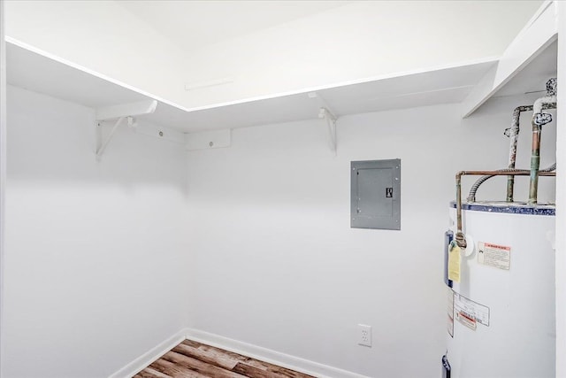 5960 Meadow Way, Beaumont, TX 77707 - spacious closet featuring water heater, electric panel, and wood finished floors
