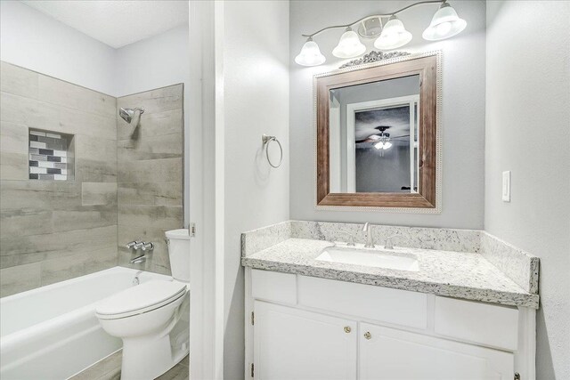5960 Meadow Way, Beaumont, TX 77707 - bathroom with toilet, vanity, shower / tub combination, and a ceiling fan