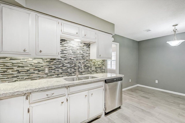 5960 Meadow Way, Beaumont, TX 77707 - kitchen with dishwasher, a sink, backsplash, baseboards, and light wood-type flooring