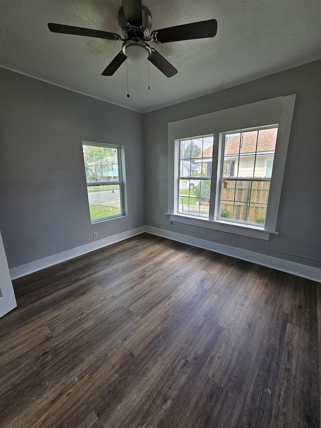 empty room featuring ceiling fan and dark hardwood / wood-style floors