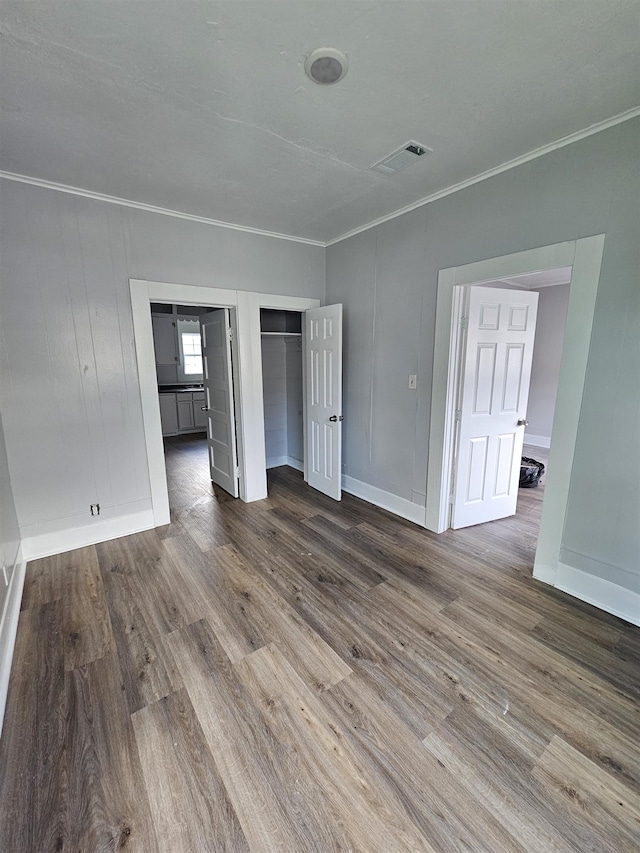 interior space featuring crown molding and hardwood / wood-style flooring