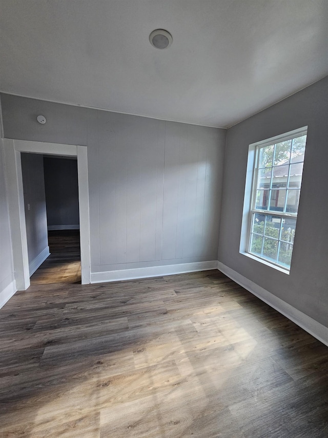 unfurnished room with wood-type flooring