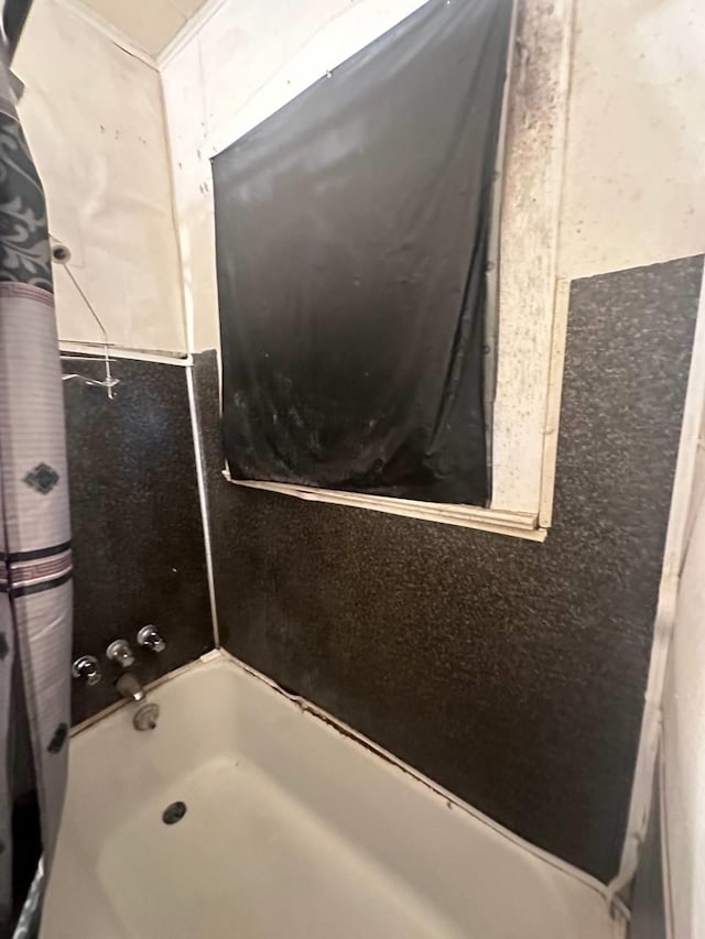 bathroom with shower / bath combination with curtain