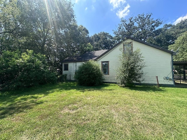 view of side of property featuring a yard