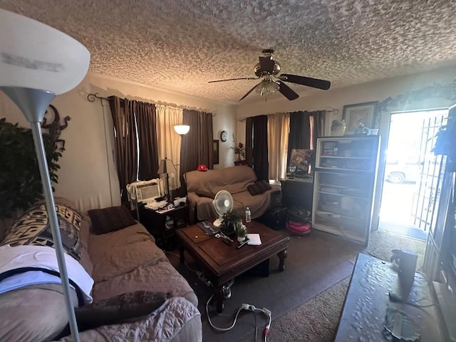 living room with ceiling fan and a textured ceiling