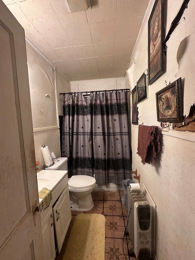 bathroom featuring tile patterned flooring, vanity, toilet, and heating unit