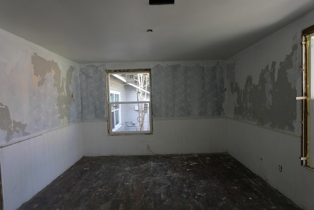 spare room featuring a wainscoted wall