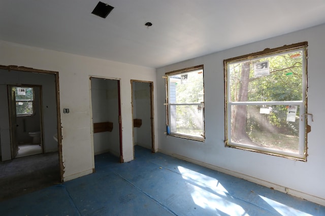 unfurnished bedroom featuring multiple closets