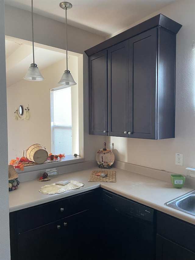 kitchen featuring dishwasher, decorative light fixtures, and sink