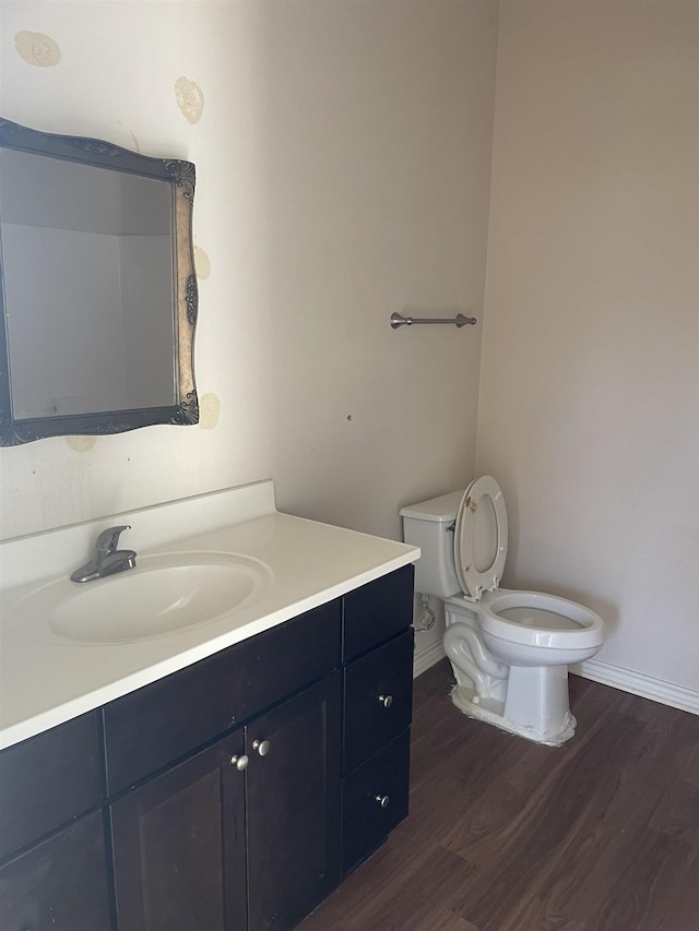 bathroom with vanity, toilet, and wood-type flooring