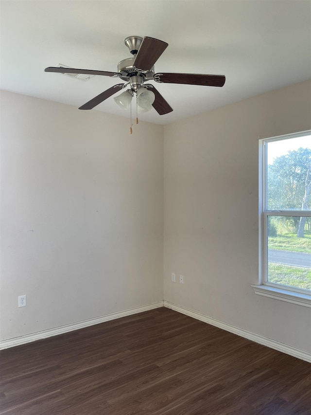 unfurnished room featuring dark hardwood / wood-style flooring, a wealth of natural light, and ceiling fan