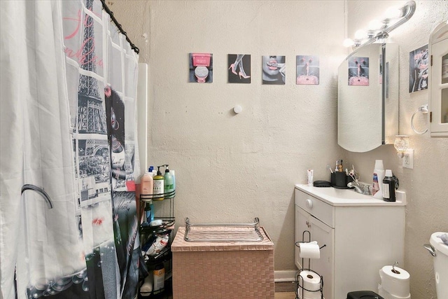 bathroom featuring hardwood / wood-style flooring, vanity, and toilet