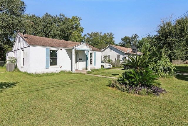 view of front of home featuring cooling unit and a front yard