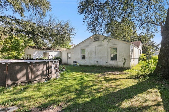 back of house featuring a yard