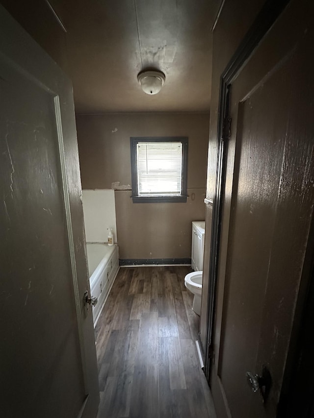 3123 13th St, Port Arthur, TX 77642 - bathroom with toilet, wood finished floors, and a tub