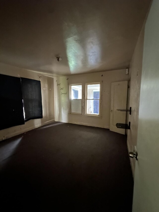 3123 13th St, Port Arthur, TX 77642 - unfurnished living room featuring dark carpet