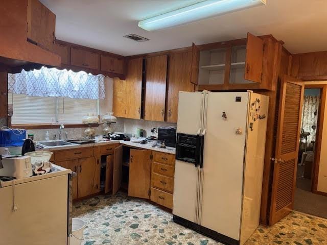 kitchen featuring sink and white fridge with ice dispenser