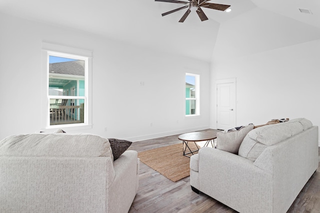 living room featuring wood-type flooring, vaulted ceiling, and ceiling fan