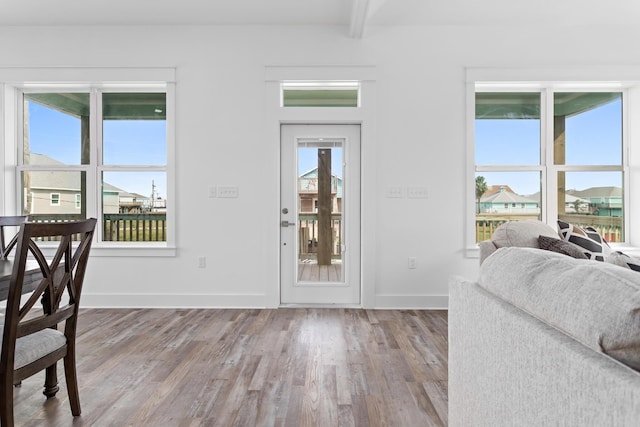 entrance foyer featuring hardwood / wood-style flooring and beamed ceiling