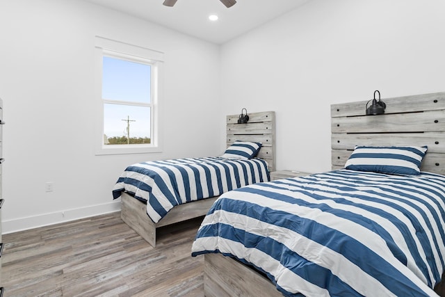 bedroom with wood-type flooring and ceiling fan