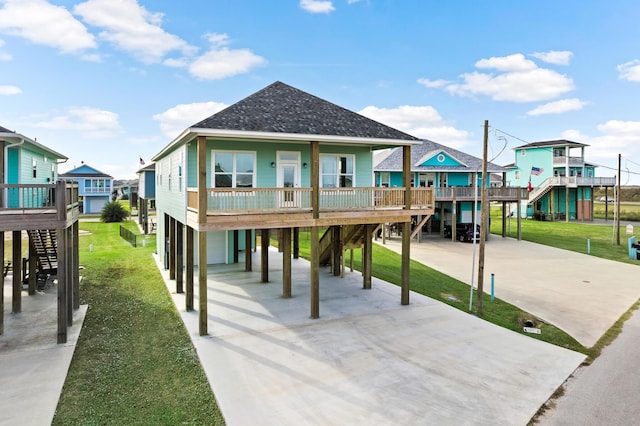 coastal inspired home featuring a carport and a front yard