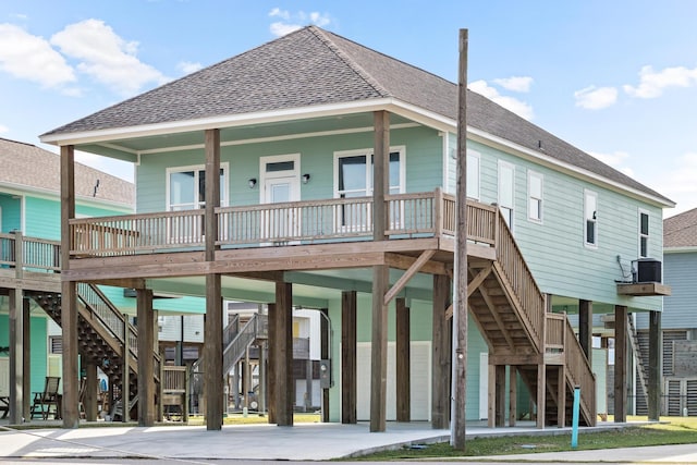 back of property with a porch and a carport