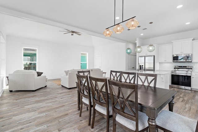 dining area featuring ceiling fan, light hardwood / wood-style floors, and sink