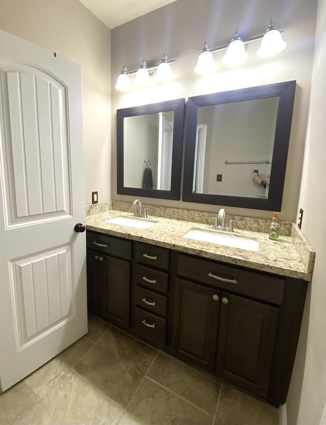 bathroom featuring tile patterned flooring and vanity