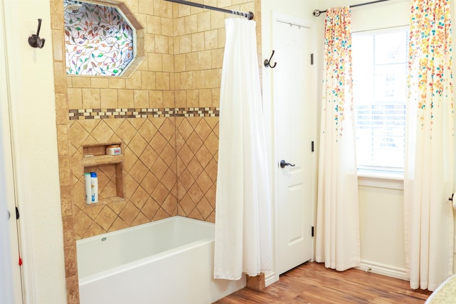 9861 Fm 1442, Orange, TX 77630 - full bathroom with shower / bath combination with curtain, wood finished floors, plenty of natural light, and baseboards