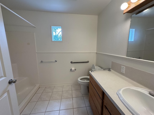 bathroom with a shower, tile patterned floors, vanity, and toilet