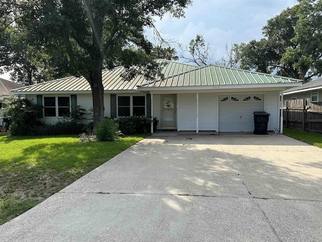 ranch-style home with a front lawn and a garage