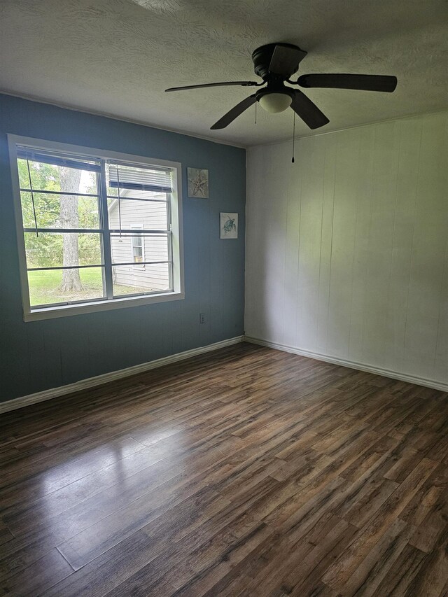 spare room featuring a textured ceiling, dark hardwood / wood-style flooring, and ceiling fan